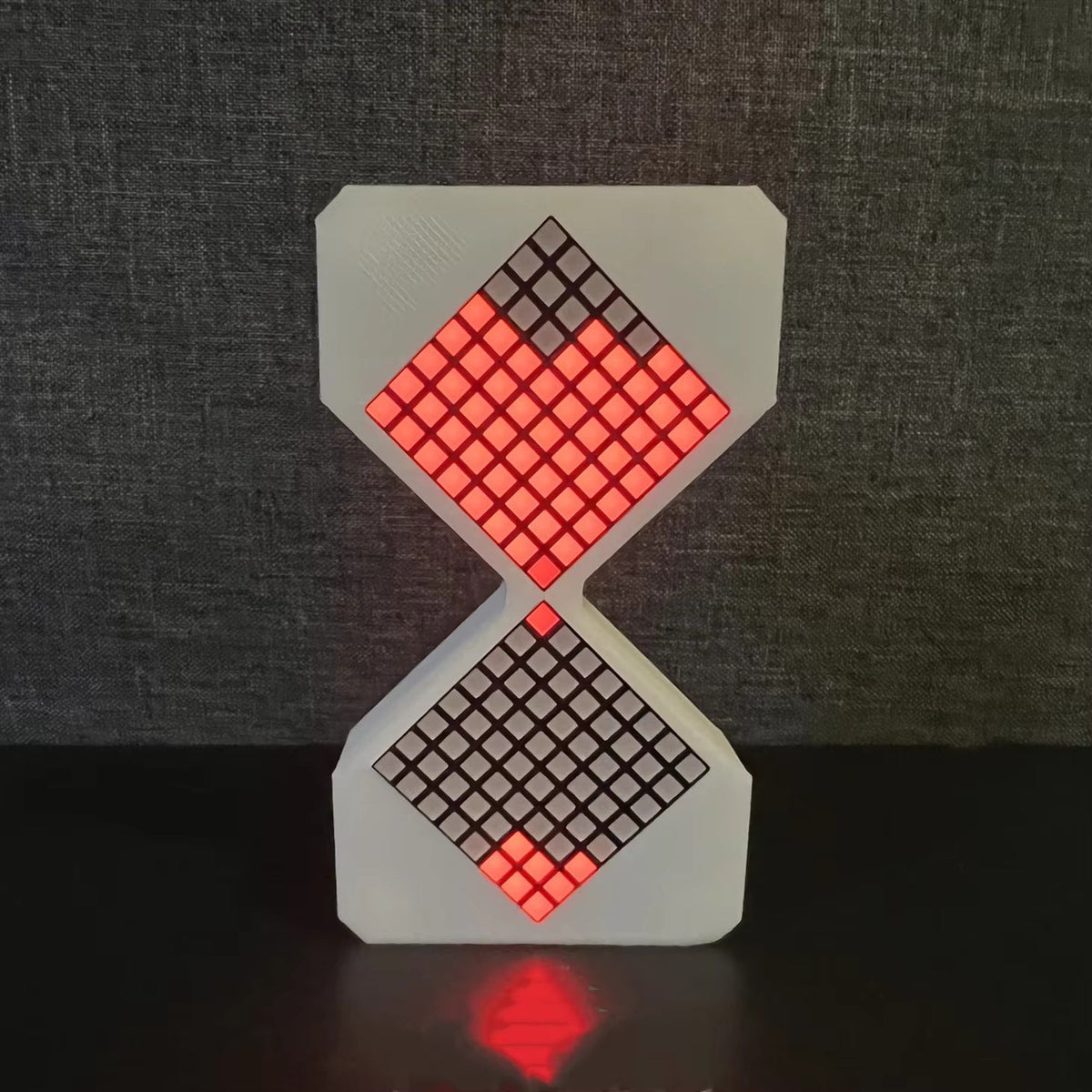 3D-printed electronic hourglass with glowing red LED pixel sand