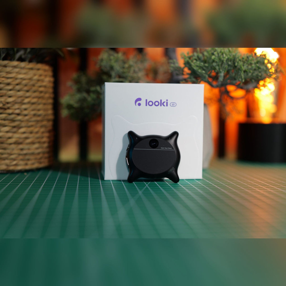 Black Looki L1 AI wearable camera standing in front of its box