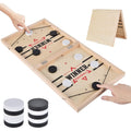 Foldable wooden slingshot table game with black and white pucks