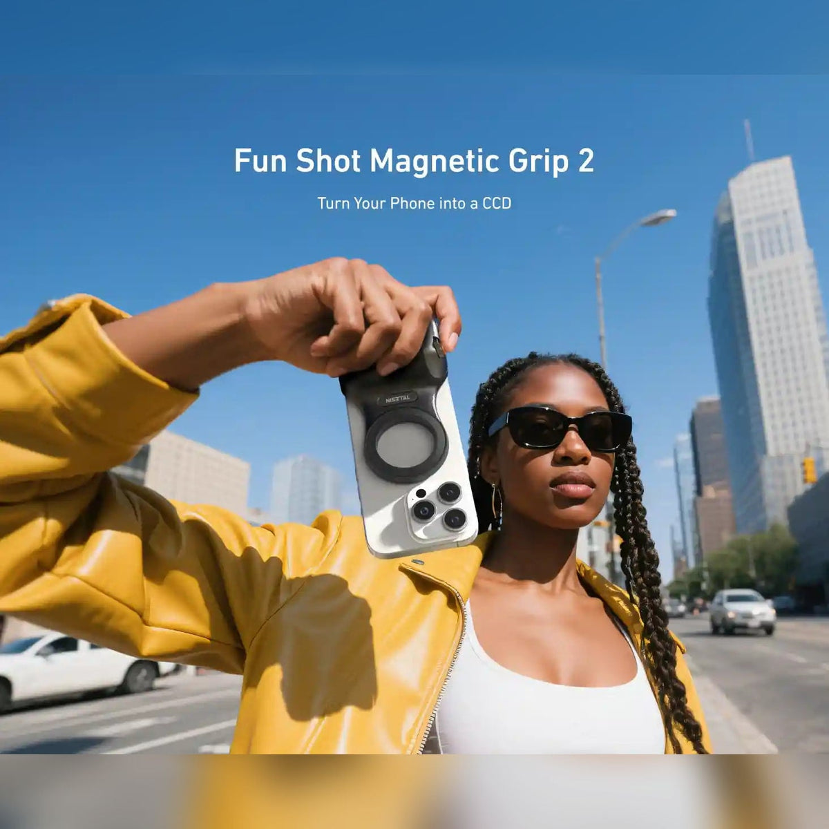 Woman taking a street photo with a phone and the TELESIN Fun Shot Magnetic Grip 2